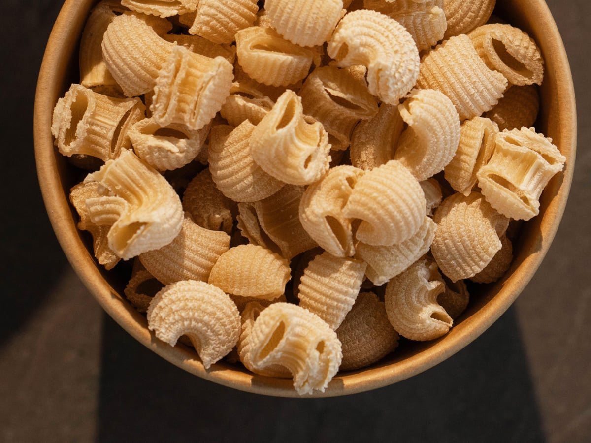 Pipe Rigate — small ridged elbow pasta in a wooden bowl